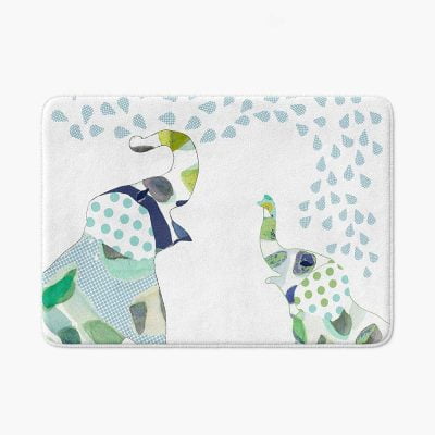 A white microfiber non slip bath mat for kids featuring a playful blue and green elephant print. Mold and mildew resistant, plush, soft, non-slip, machine washable, and quick drying.