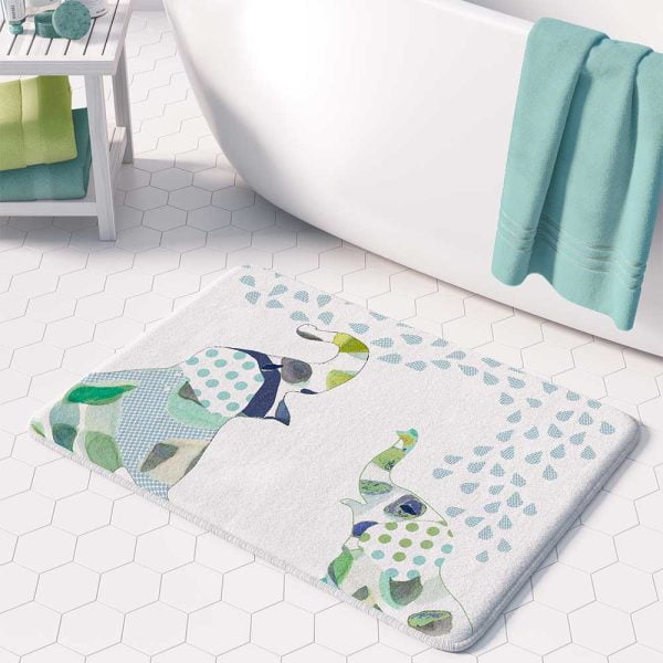 A white microfiber non slip bath mat for kids featuring a playful blue and green elephant print. Mold and mildew resistant, plush, soft, non-slip, machine washable, and quick drying.