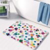 A vibrant and playful microfiber bath mat for kids, adorned with colorful polka dots in various sizes. Non-slip, quick-drying, and mold-resistant.