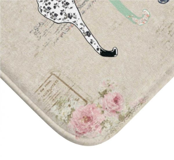 Close-up of a beige and pink rose floral design on a cat bath mat.