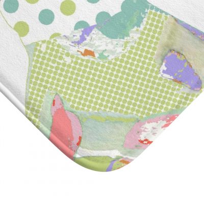 A white microfiber non slip bath mat for kids featuring a playful pink and green elephant print. Mold and mildew resistant, plush, soft, machine washable, and quick drying.