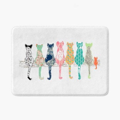 White bath mat adorned with floral cats pattern