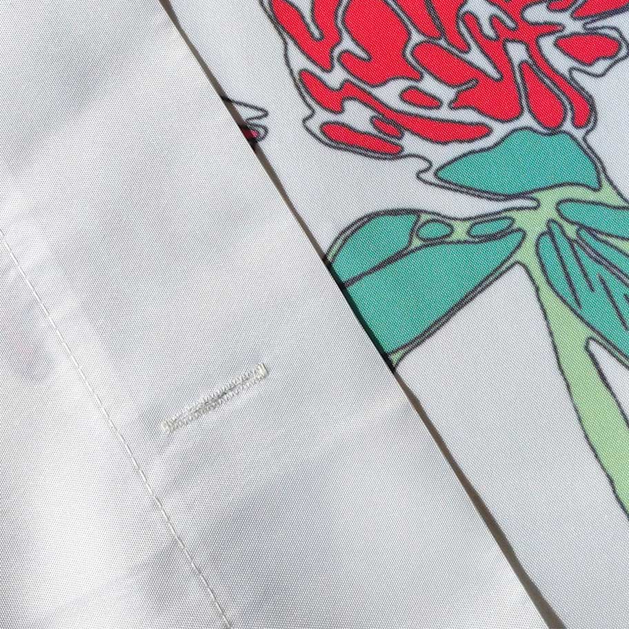 Premium fabric shower curtain featuring heavy gauge textured fabric, fully hemmed seams, and sewn-in buttonholes for convenient hook placement.
