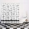 Black and white floral shower curtain with hand-drawn rose design hanging in a modern bathroom