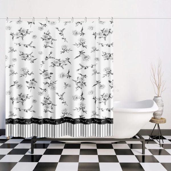 Black and white floral shower curtain with hand-drawn rose design hanging in a modern bathroom