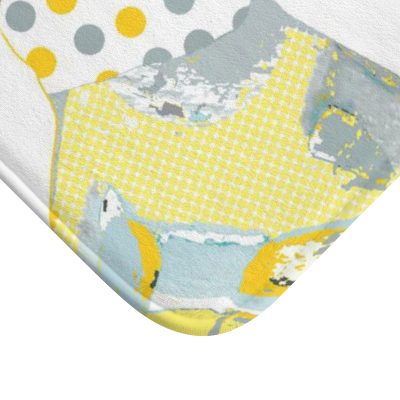 A kids bath mat featuring a charming grey and yellow elephant print, perfect for a kids' bathroom. Mold and mildew resistant, quick-drying, non-slip plush microfiber, washable.