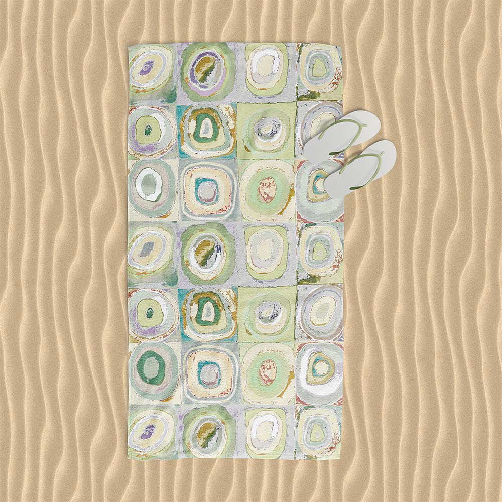 Green, yellow, and gray artistic abstract patterned beach towel.