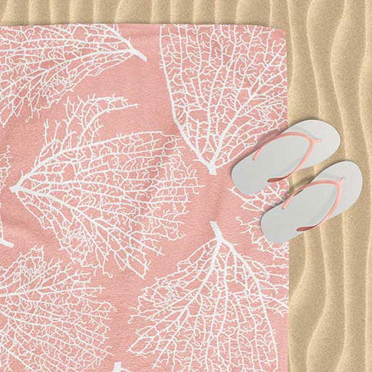 Beach towel with elegant tropical coral pink pattern.