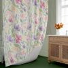 Top view of the floral shower curtain cascading down.