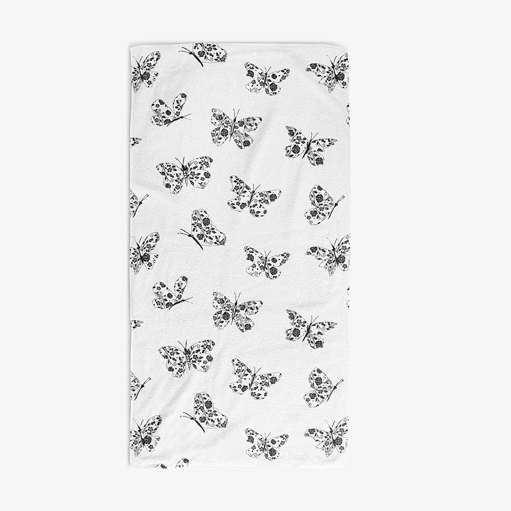 Bath towel with black and white abstract butterfly print, ideal for a modern girls' bathroom.