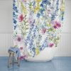 Floral shower curtain with lilac, purple, pink, and yellow flowers and sturdy metal grommets for hanging