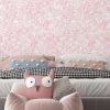 Soft pink watercolor leaves wallpaper in a girl's bedroom, adding a touch of elegance and charm
