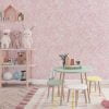 Soft pink watercolor leaves wallpaper in a kids' playroom, adding a fun and whimsical touch