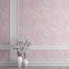 Soft pink watercolor leaves wallpaper in a hallway, creating a serene and elegant atmosphere