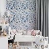 Playful blue watercolor floral wallpaper in a kids' bedroom