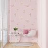 Pink puppy dog wallpaper in kids' playroom.