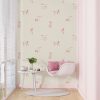 Pink puppy dog animal wallpaper in beige kids' playroom.