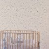 Lavender grey micro stars wallpaper in baby nursery with crib