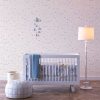 Lavender grey micro stars wallpaper in baby nursery with crib
